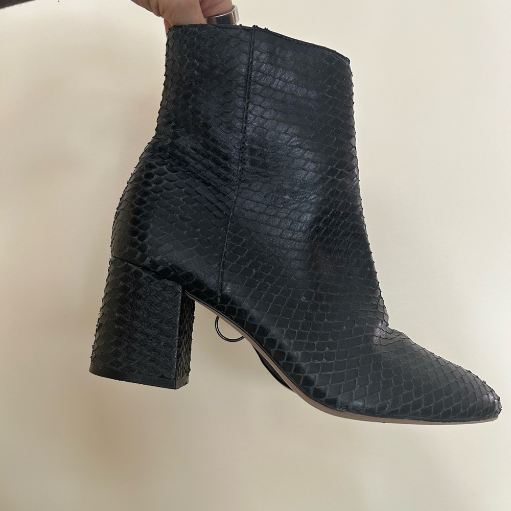 Able black leather snakeskin bootie.